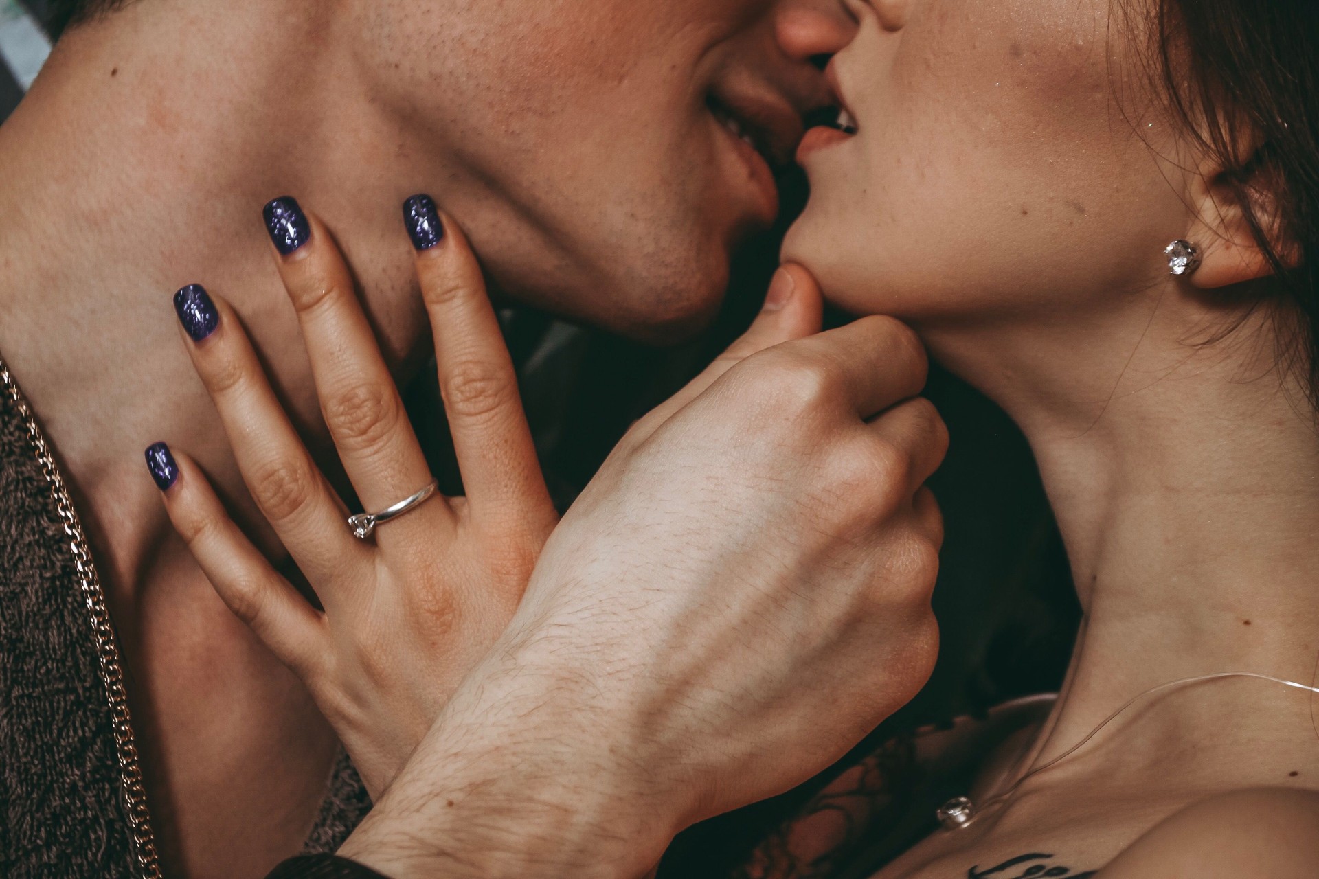Midsection Of Romantic Couple Kissing At Home