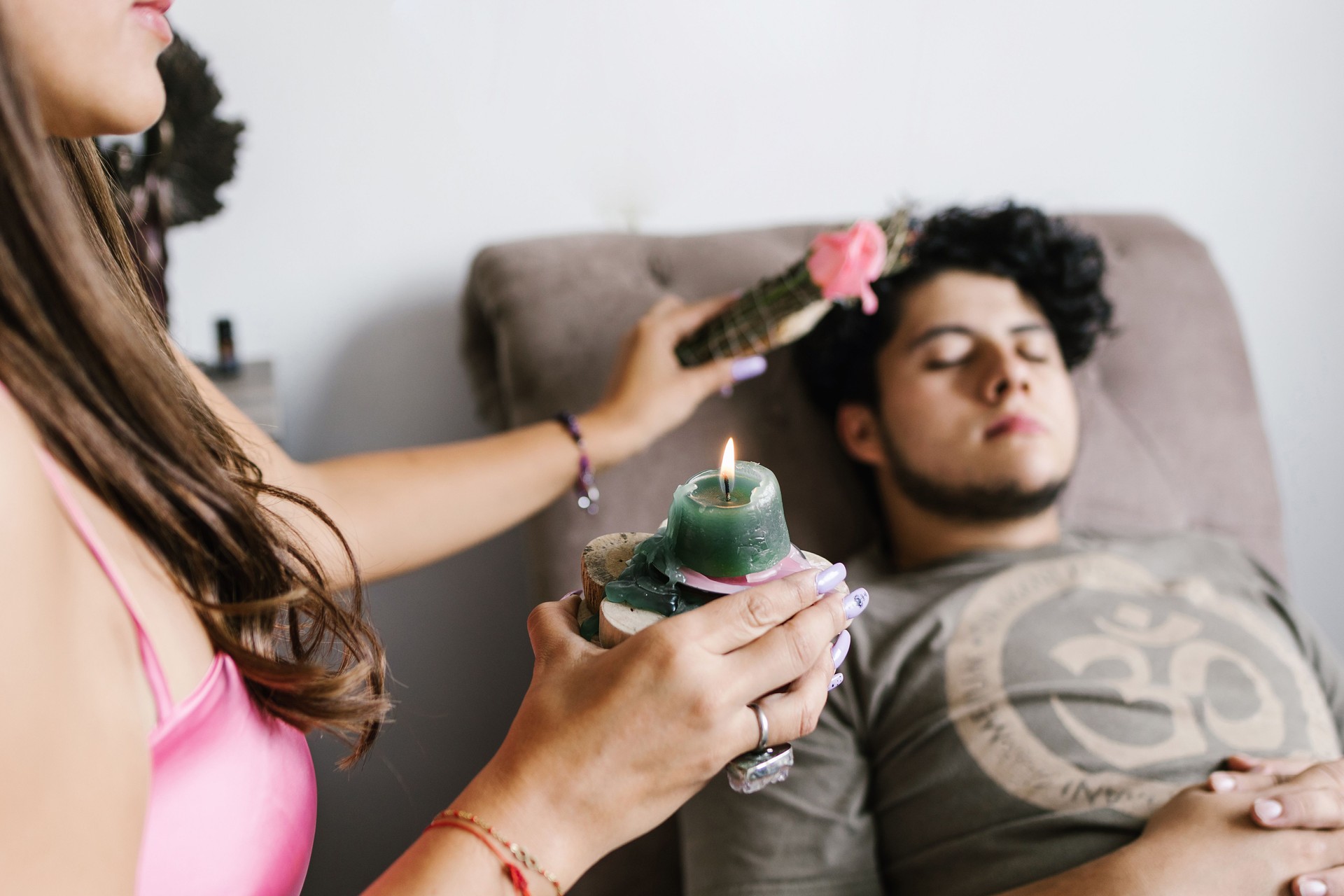 Young mexican male in healing session lying on the divan in holistic therapy in Latin America